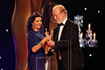 Actor Sean McGinley presents Deirdre O’Kane with the IFTA Award for Best Actress in Film for Noble
