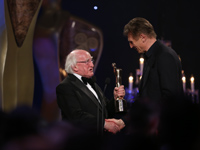 Liam Neeson accepts his award from President Michael D. Higgins	