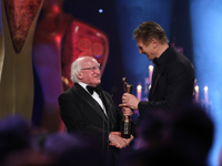 Liam Neeson accepts his award from President Michael D. Higgins	